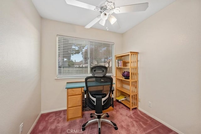 carpeted home office featuring ceiling fan