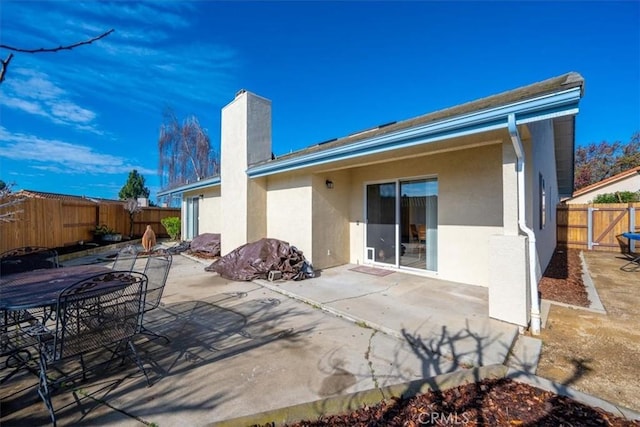 rear view of property featuring a patio area