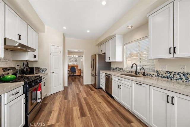 kitchen featuring sink, light hardwood / wood-style flooring, stainless steel appliances, light stone countertops, and white cabinets