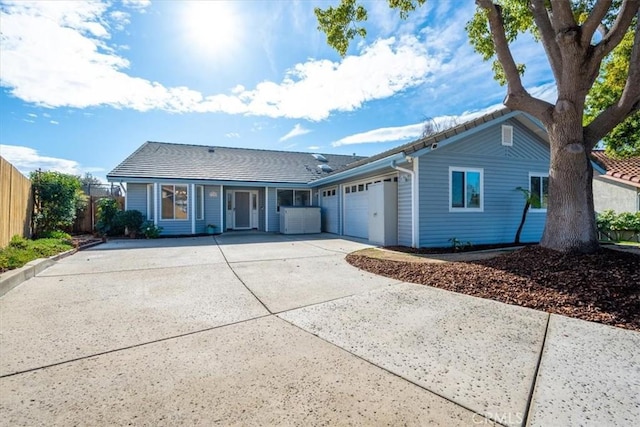 rear view of property featuring a garage