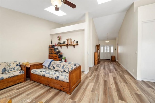 interior space featuring a skylight and light hardwood / wood-style floors