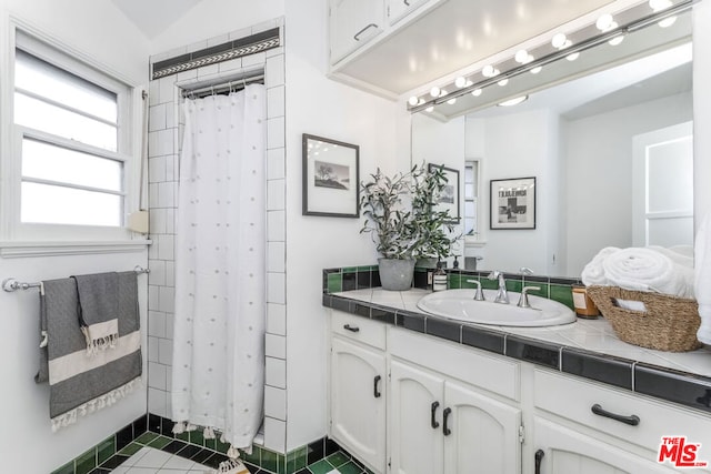 bathroom featuring vanity and walk in shower