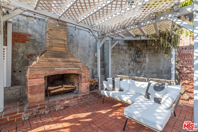 view of patio / terrace featuring an outdoor fireplace