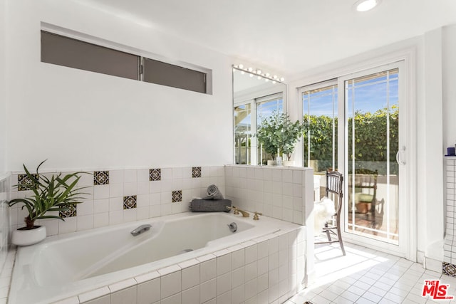 bathroom featuring tile patterned flooring and tiled bath