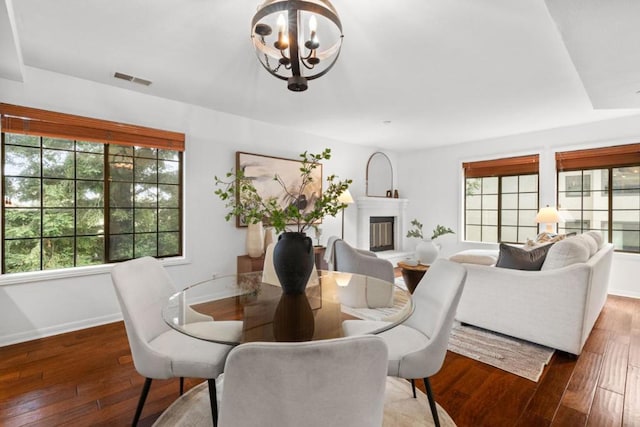 dining room featuring dark wood-type flooring and a chandelier