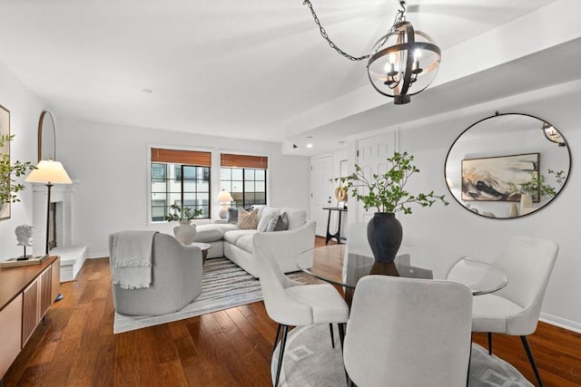 dining space with hardwood / wood-style flooring and a notable chandelier