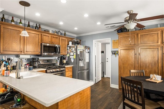 kitchen featuring pendant lighting, stainless steel appliances, crown molding, and kitchen peninsula