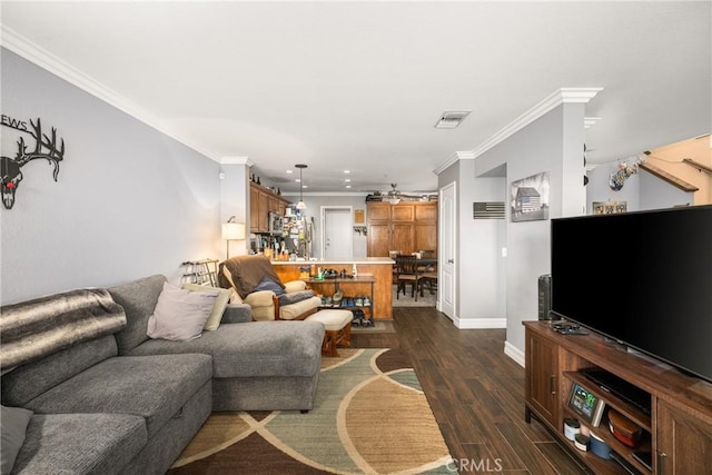 living room with dark hardwood / wood-style flooring and ornamental molding