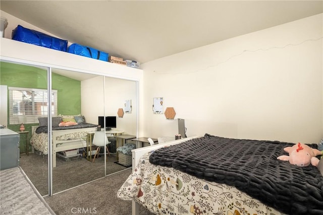 carpeted bedroom featuring vaulted ceiling and a closet