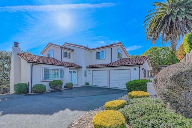 mediterranean / spanish-style home with a garage