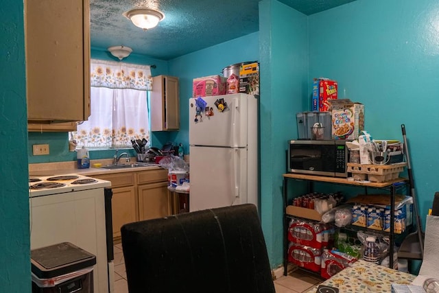 kitchen featuring sink, light tile patterned floors, a textured ceiling, and white appliances