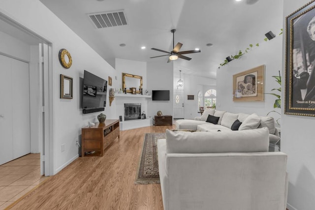 living room with ceiling fan and light wood-type flooring