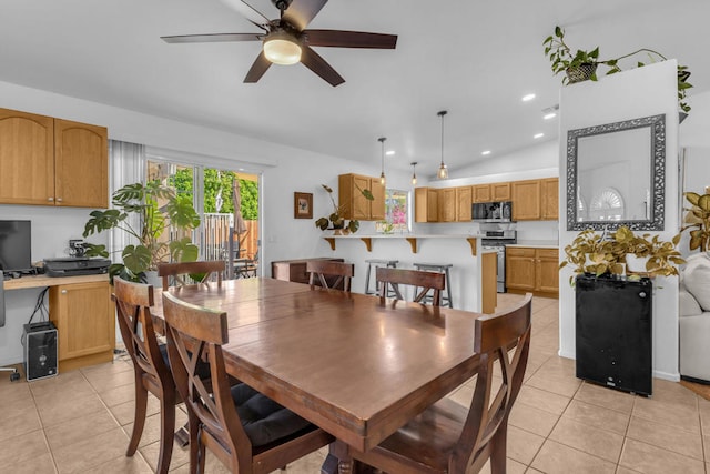 tiled dining space with vaulted ceiling and ceiling fan