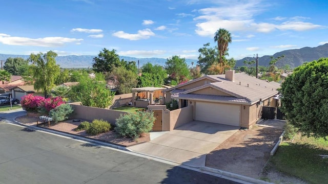 view of front of property with a mountain view and a garage