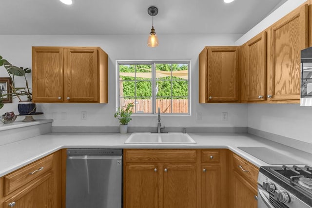 kitchen with stainless steel appliances, sink, and decorative light fixtures