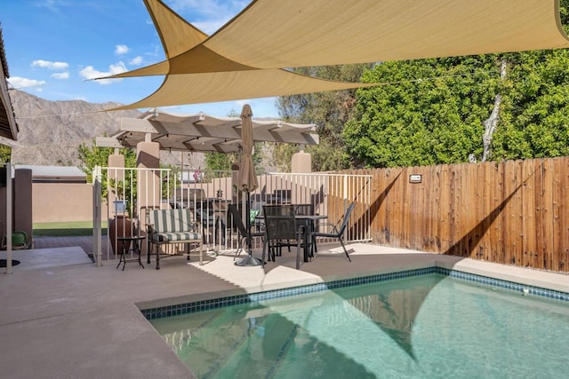 view of pool with a pergola, a mountain view, and a patio area