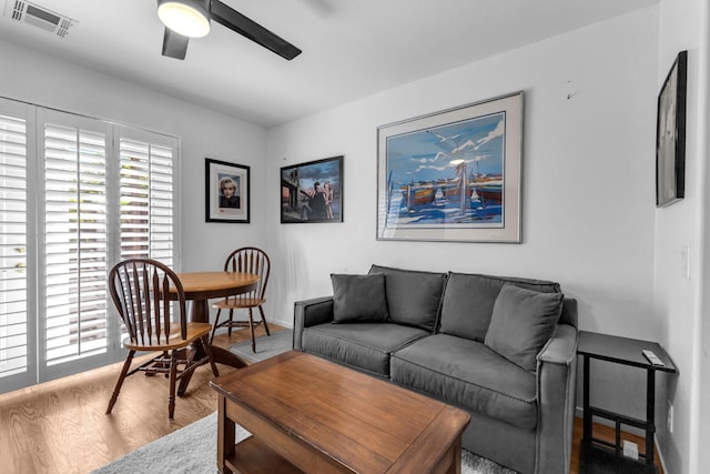 living room featuring hardwood / wood-style flooring and ceiling fan