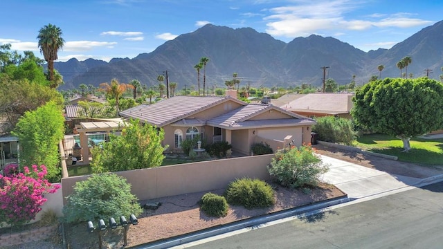 exterior space with a garage and a mountain view