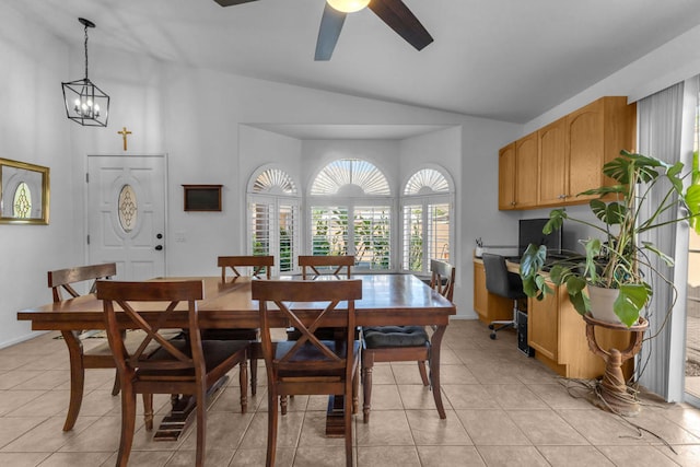 dining area with lofted ceiling, light tile patterned floors, and ceiling fan