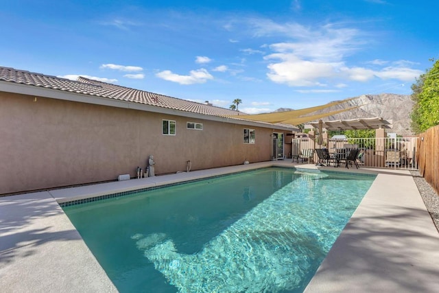 view of pool with a pergola and a mountain view