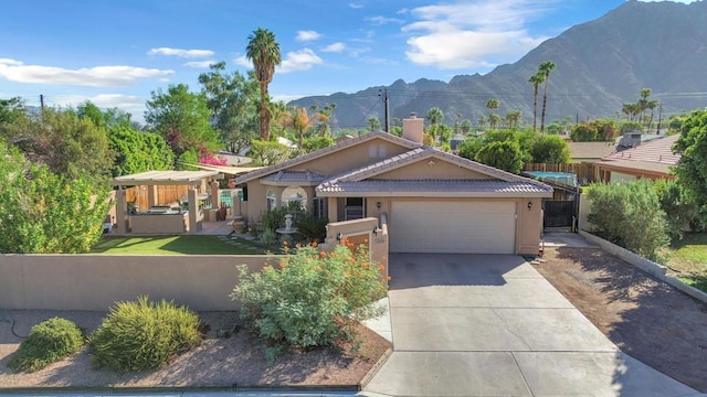 view of front facade featuring a mountain view and a garage