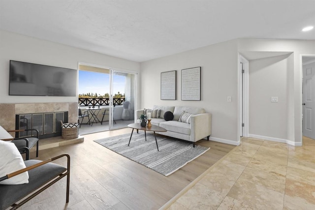 living room featuring light hardwood / wood-style floors and a tile fireplace