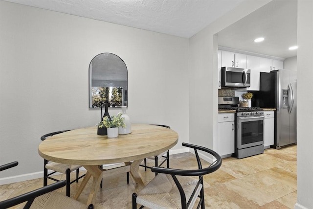 dining space featuring baseboards and recessed lighting