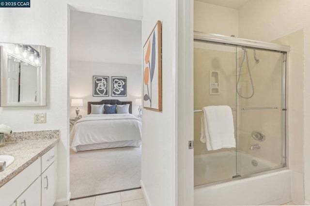 bathroom featuring enclosed tub / shower combo, vanity, and tile patterned floors