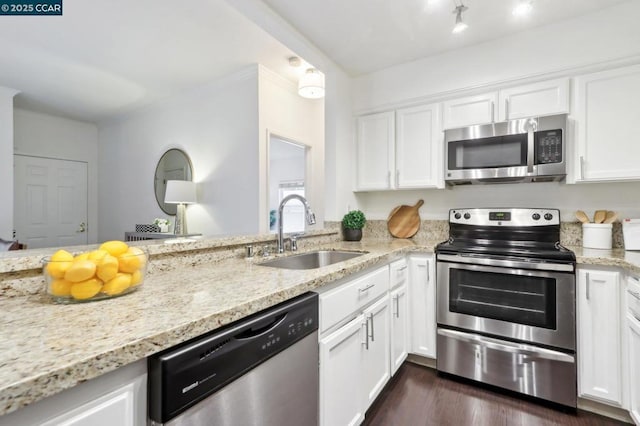 kitchen featuring dark wood-type flooring, sink, white cabinetry, light stone counters, and stainless steel appliances