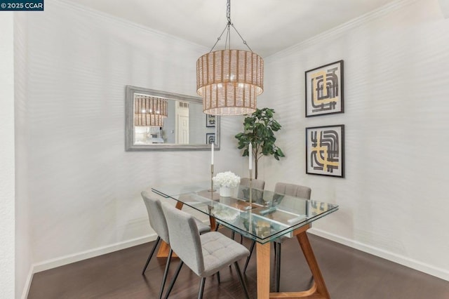 dining area with crown molding, a notable chandelier, and dark hardwood / wood-style flooring