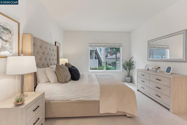 bedroom featuring light carpet