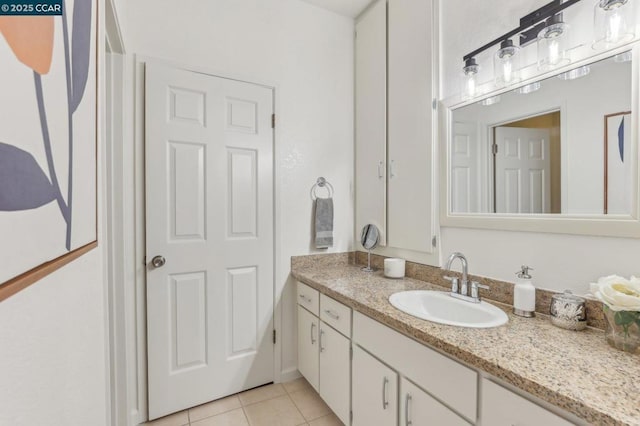 bathroom featuring tile patterned flooring and vanity