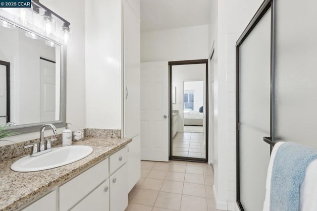 bathroom featuring vanity, an enclosed shower, and tile patterned flooring