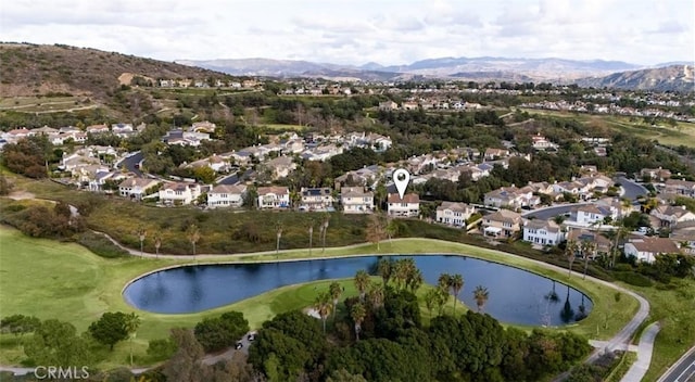 drone / aerial view featuring a water and mountain view