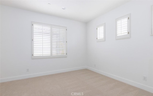 empty room with light colored carpet