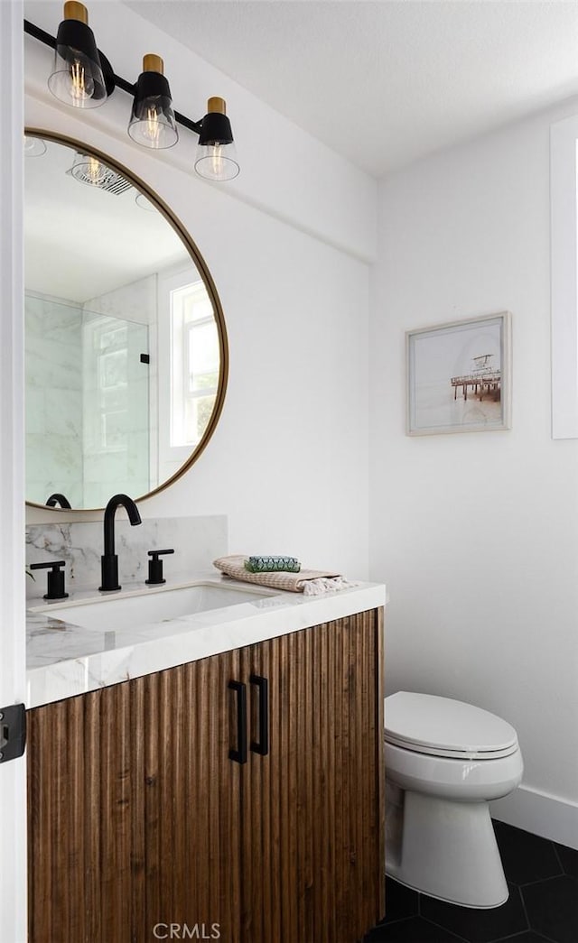 bathroom featuring tile patterned floors, toilet, and vanity