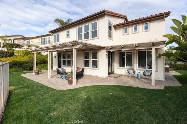 rear view of property with a patio, a yard, and a pergola