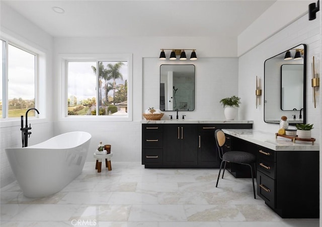 bathroom featuring vanity and a bath