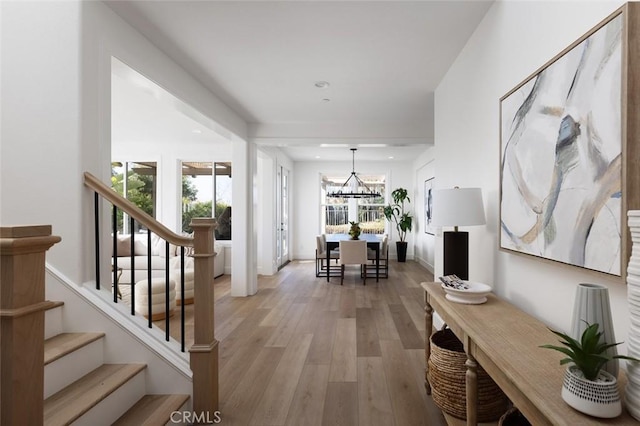 interior space with an inviting chandelier and hardwood / wood-style flooring