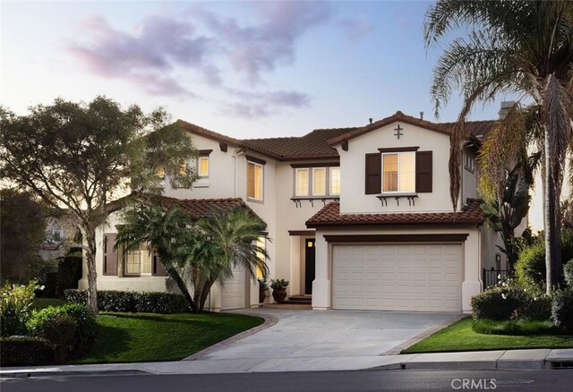 mediterranean / spanish home featuring a garage