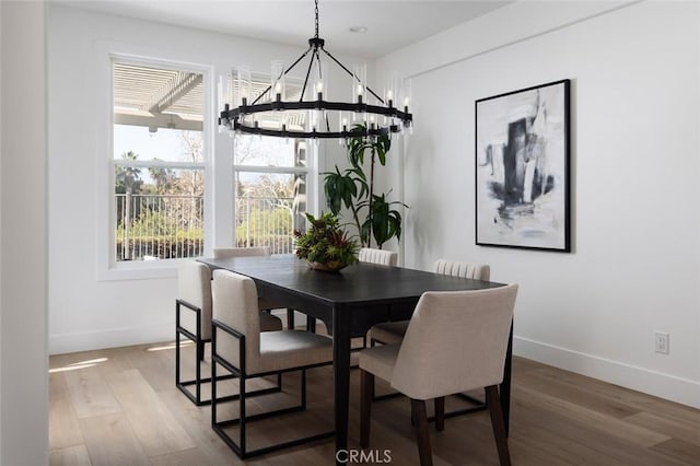 dining area featuring a chandelier and wood-type flooring