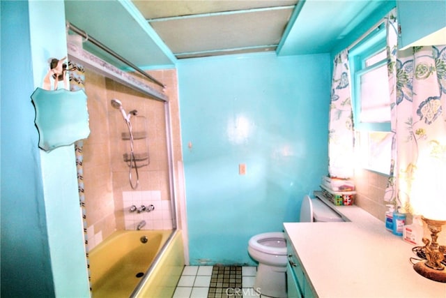 full bath featuring toilet, tile patterned floors, bathing tub / shower combination, and vanity