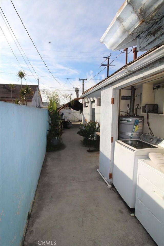 exterior space with separate washer and dryer and gas water heater