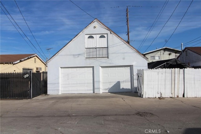 detached garage featuring fence