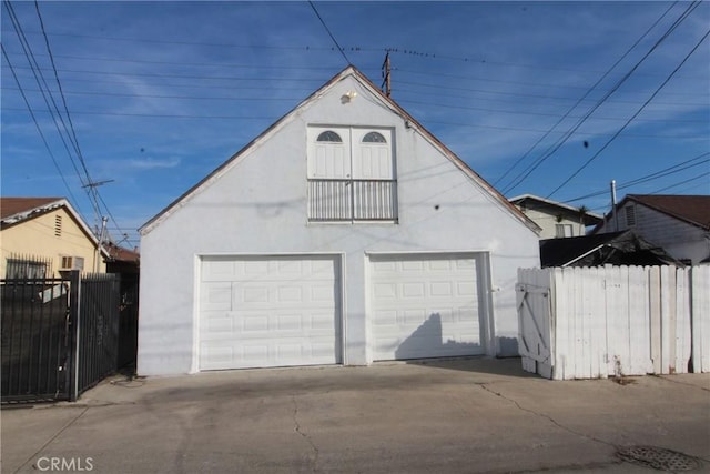 detached garage featuring a gate and fence