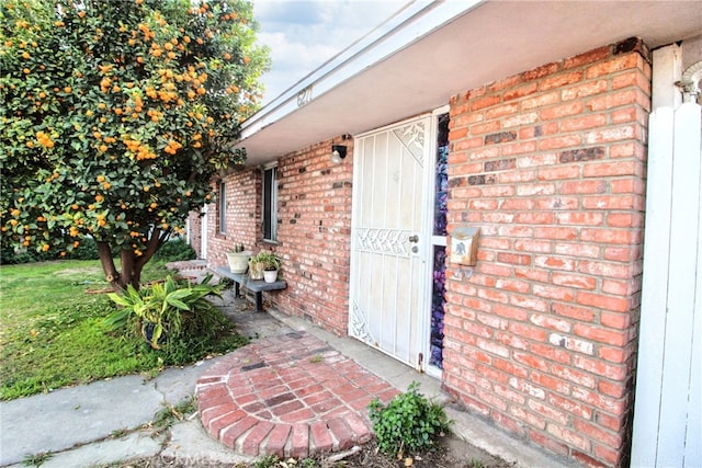 property entrance featuring brick siding