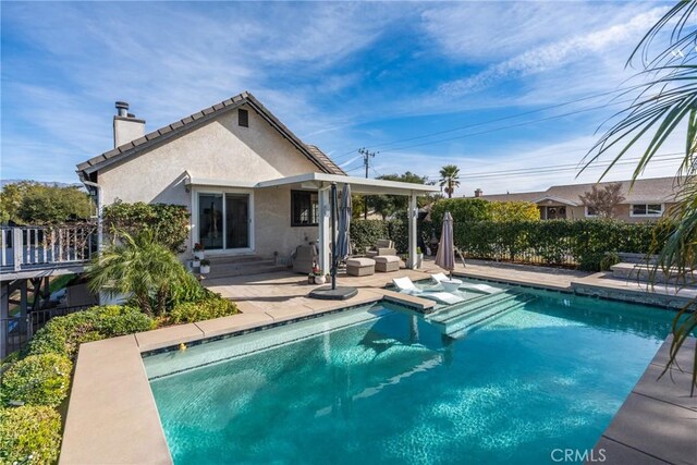 view of pool featuring a patio area and a hot tub