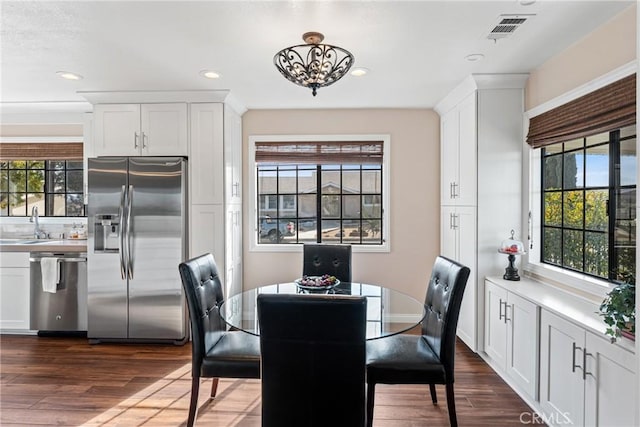 dining area featuring dark wood-type flooring