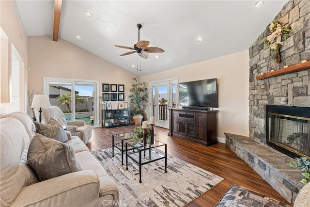 living room featuring a stone fireplace, high vaulted ceiling, beamed ceiling, dark hardwood / wood-style flooring, and ceiling fan