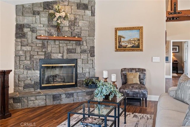 living room with hardwood / wood-style flooring and a fireplace